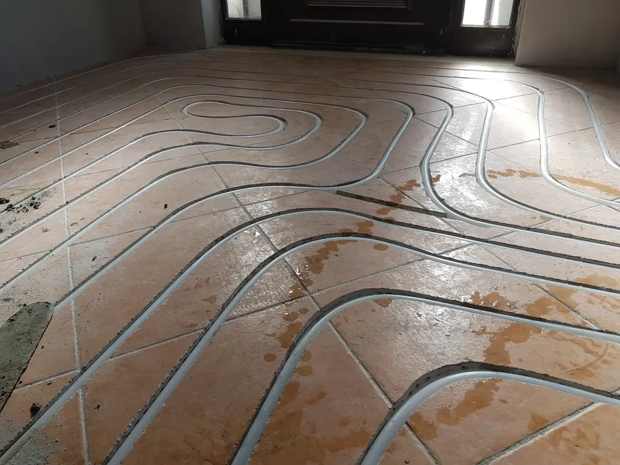 Retrofit underfloor heating pipework milled into an existing Algarve floor