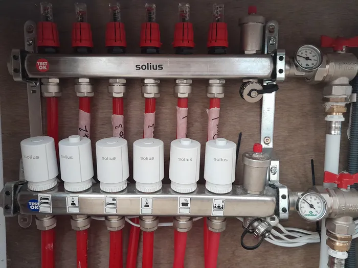 Manifold with room-by-room zone labels and pressure gauges