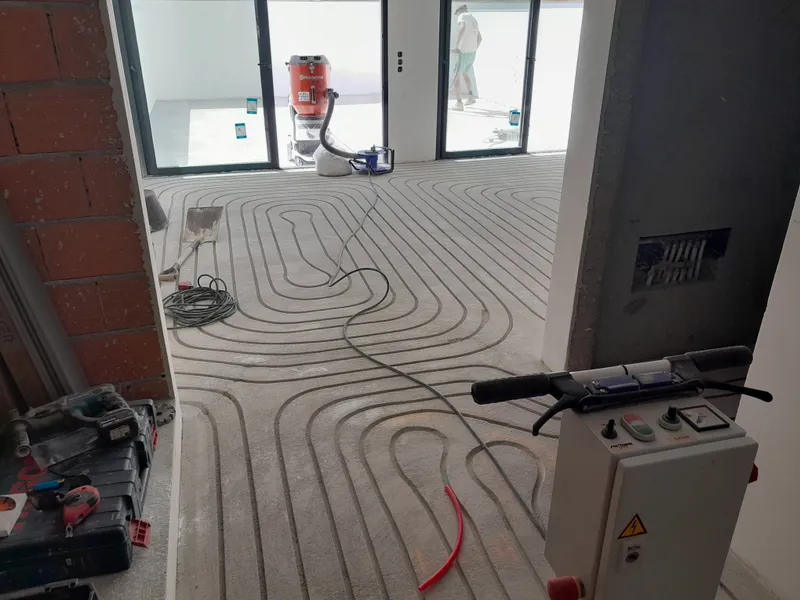 Finished milled channels in the floor, ready for pipework